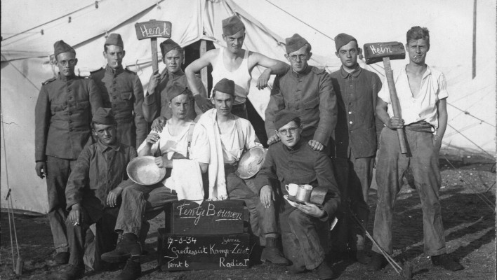 Military recruits showing name signs